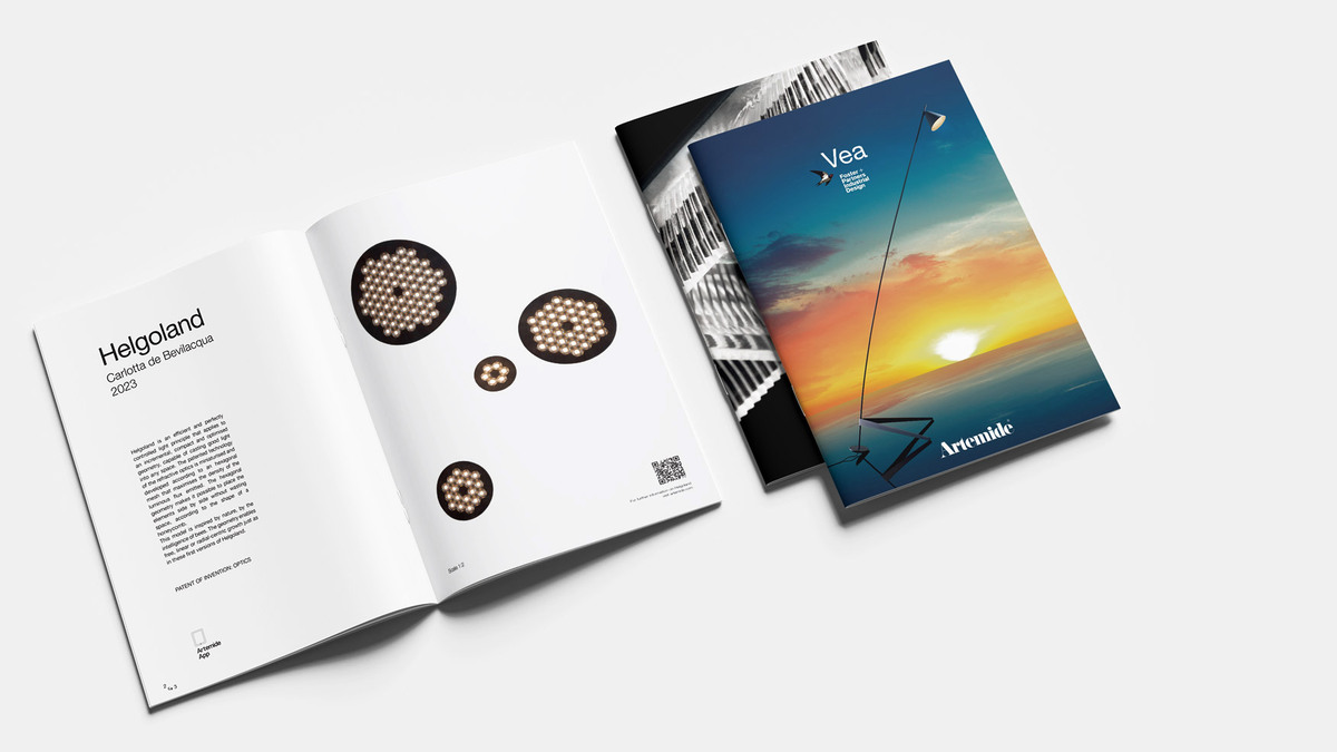 Artemide brochures open on the Helgoland, Vea and Somnĭum products, placed on a light background.