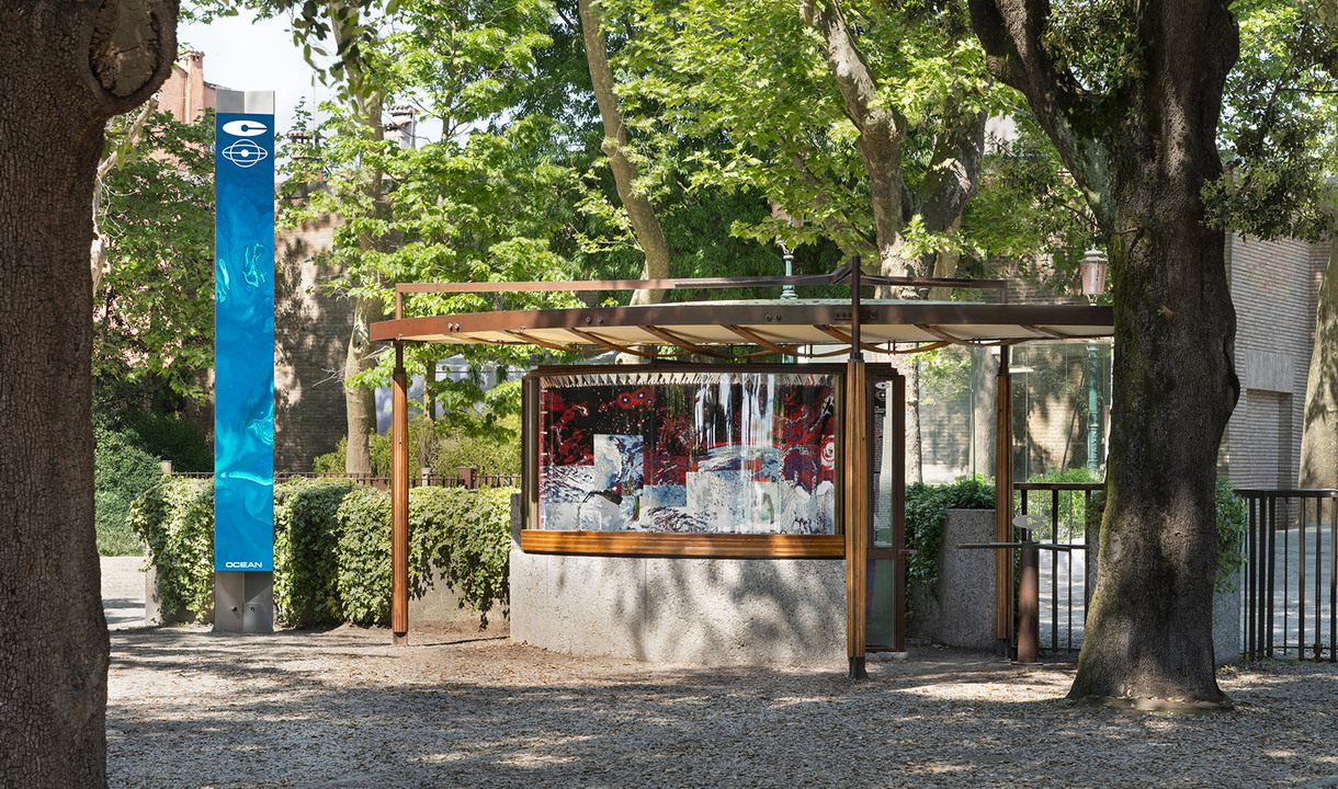 Historic Ticket Office designed by Carlo Scarpa positioned at the entrance of the Venice Biennale with people inside.