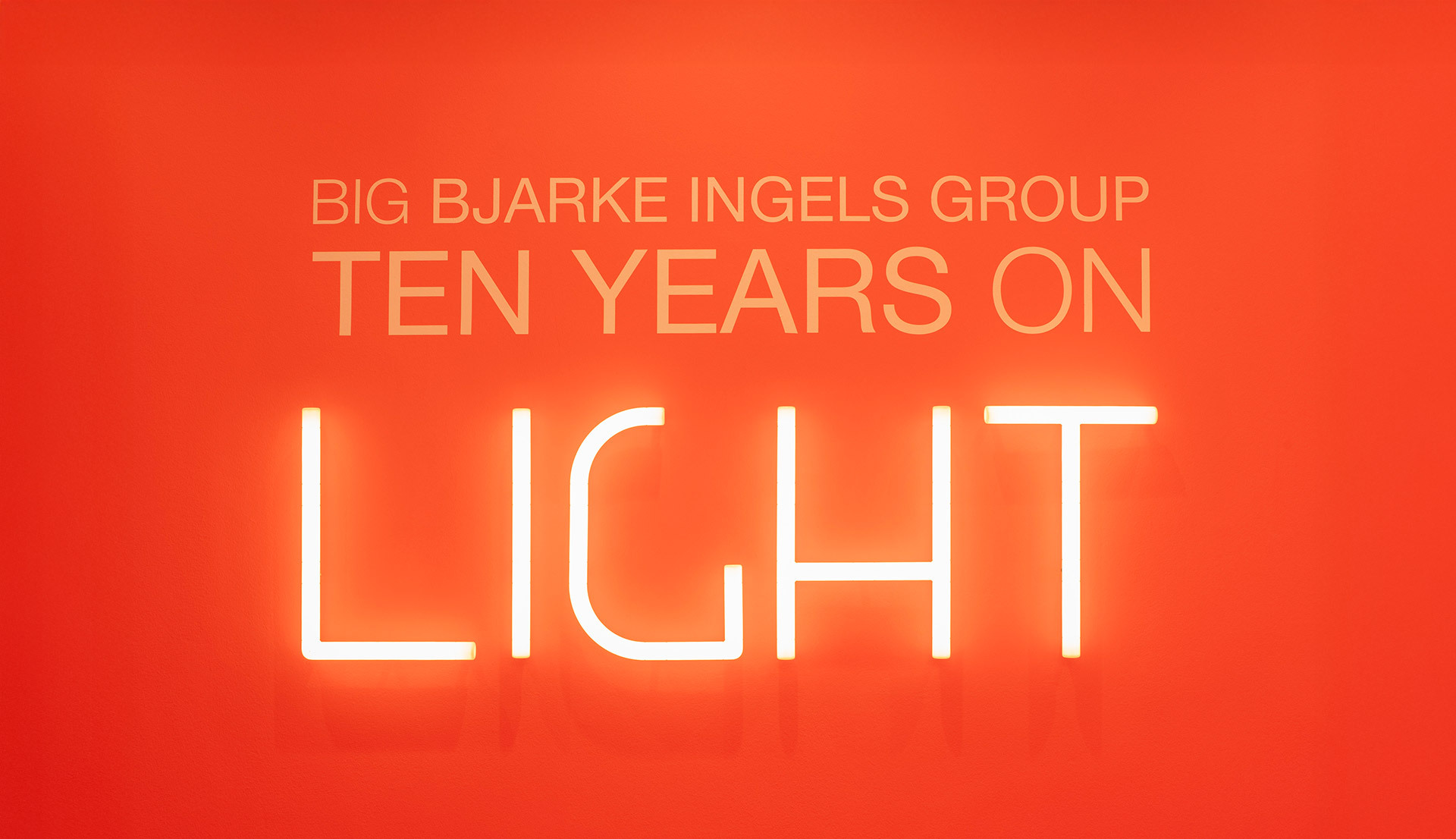 Illuminated “Ten Years on Light” lettering created with Alphabet of Light, set against a red background.