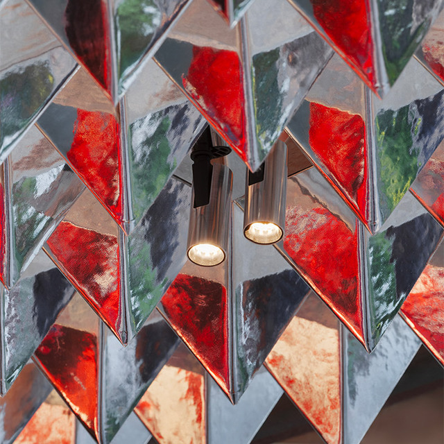 Detail of the booth ceiling with reflective panels and integrated spotlights.