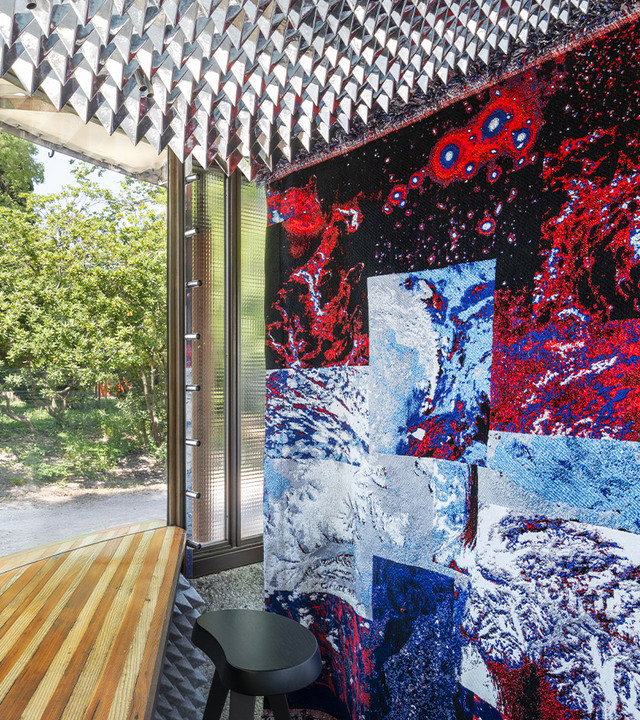 Interior of Scarpa’s ticket booth with artistic textile installation and filtered natural light.