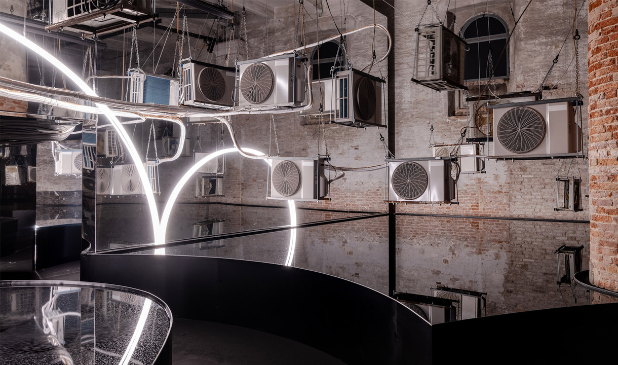 Symbol of Michelangelo Pistoletto's Third Paradise recreated with Artemide's Linea, in a room with water mirrors reflecting its shape.