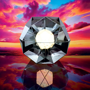 Arctic lamp with geometric mirrored surfaces, centered against a vivid sunset background. Photo by Pierpaolo Ferrari.