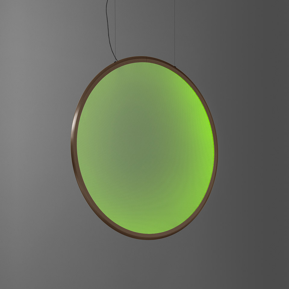 Artemide Discovery pendant lamp: large circular disc emitting vibrant green light, bronze frame, suspended by thin black cable