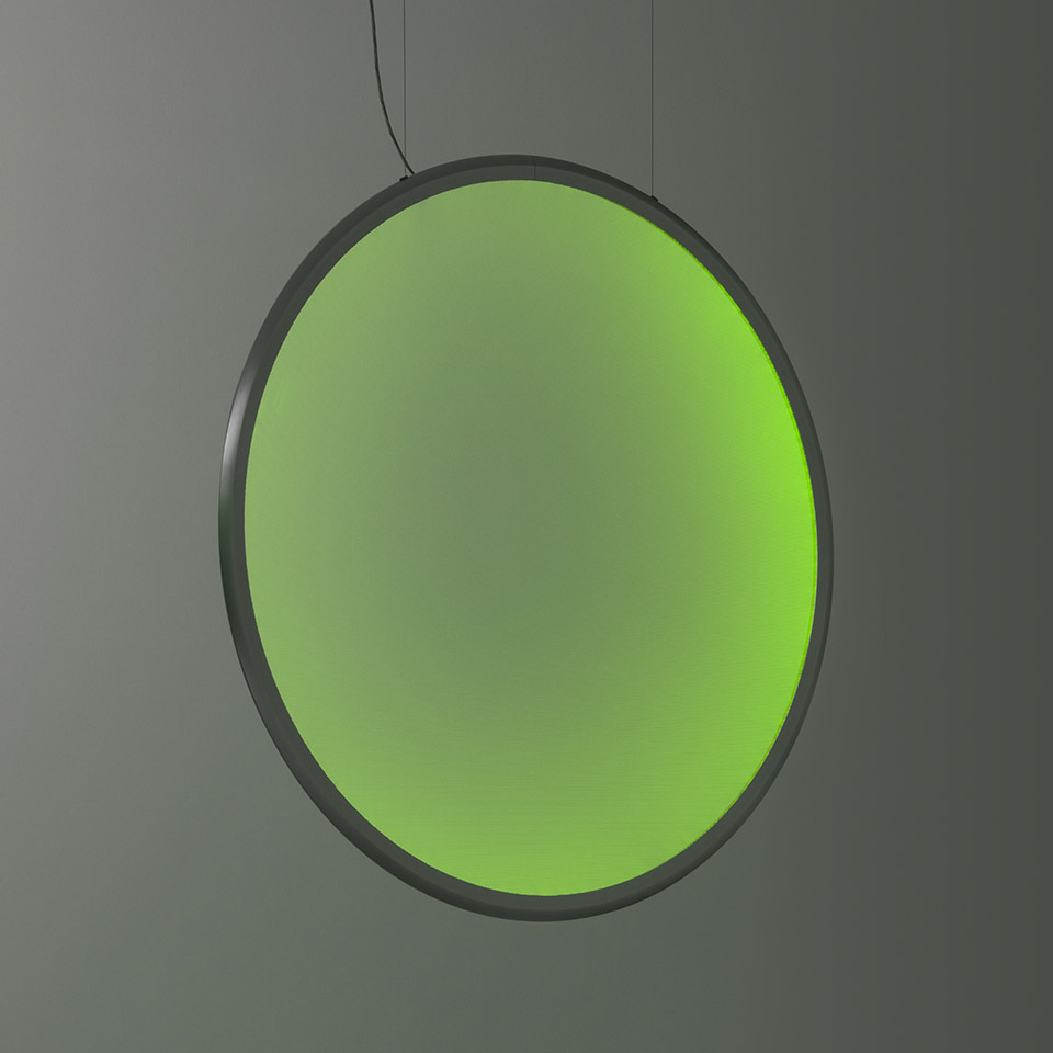 Artemide Discovery pendant lamp: large circular disc emitting vibrant green gradient light, suspended by thin cables with dark metal frame