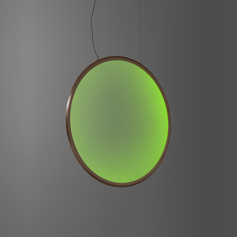 Artemide Discovery pendant lamp: large circular disc emitting vibrant green light, bronze frame, suspended by thin black cable