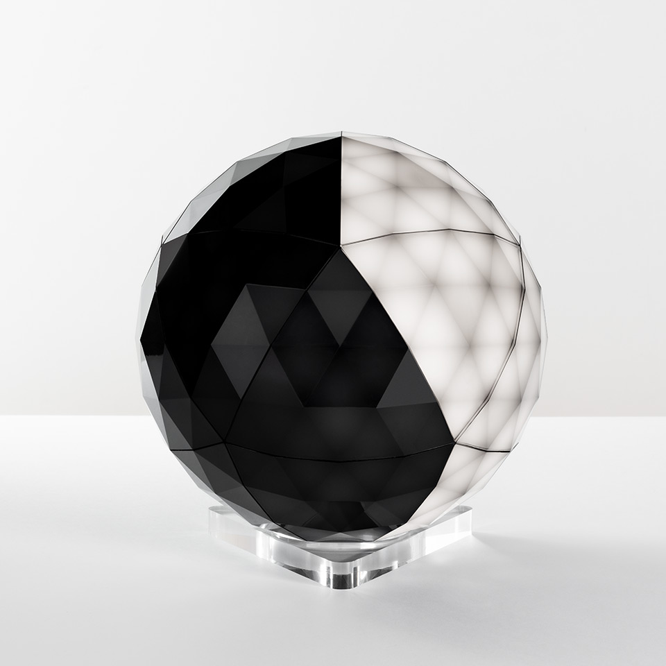 Artemide Huara table lamp: faceted spherical diffuser with black and white geometric panels on a transparent crystal base - 2