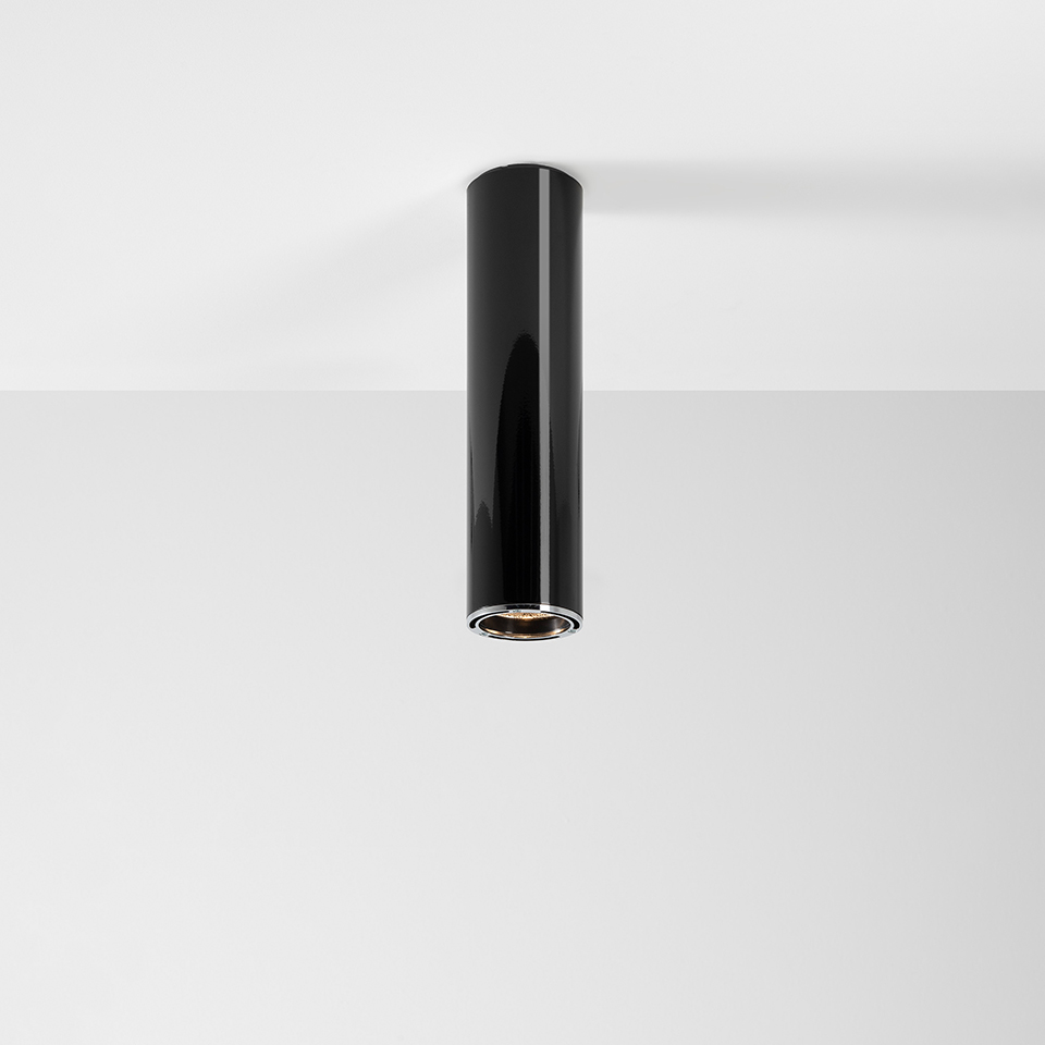 Artemide Ilio ceiling spotlight: sleek glossy black cylindrical body with integrated LED, surface-mounted downlight