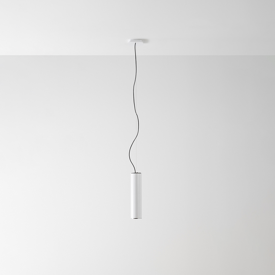 Artemide Ilio pendant lamp: slim white cylindrical body suspended by a black cable from a white ceiling canopy