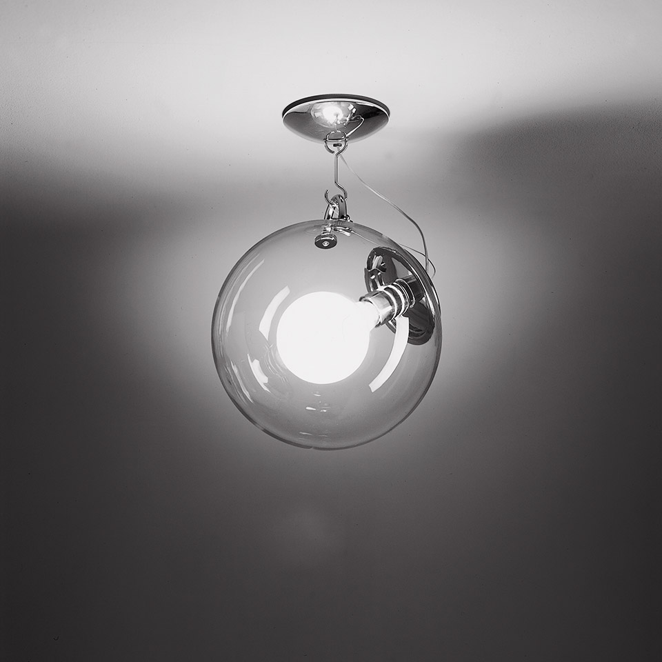 Artemide Miconos ceiling lamp: transparent blown glass sphere with chrome hardware and visible bulb, suspended from ceiling