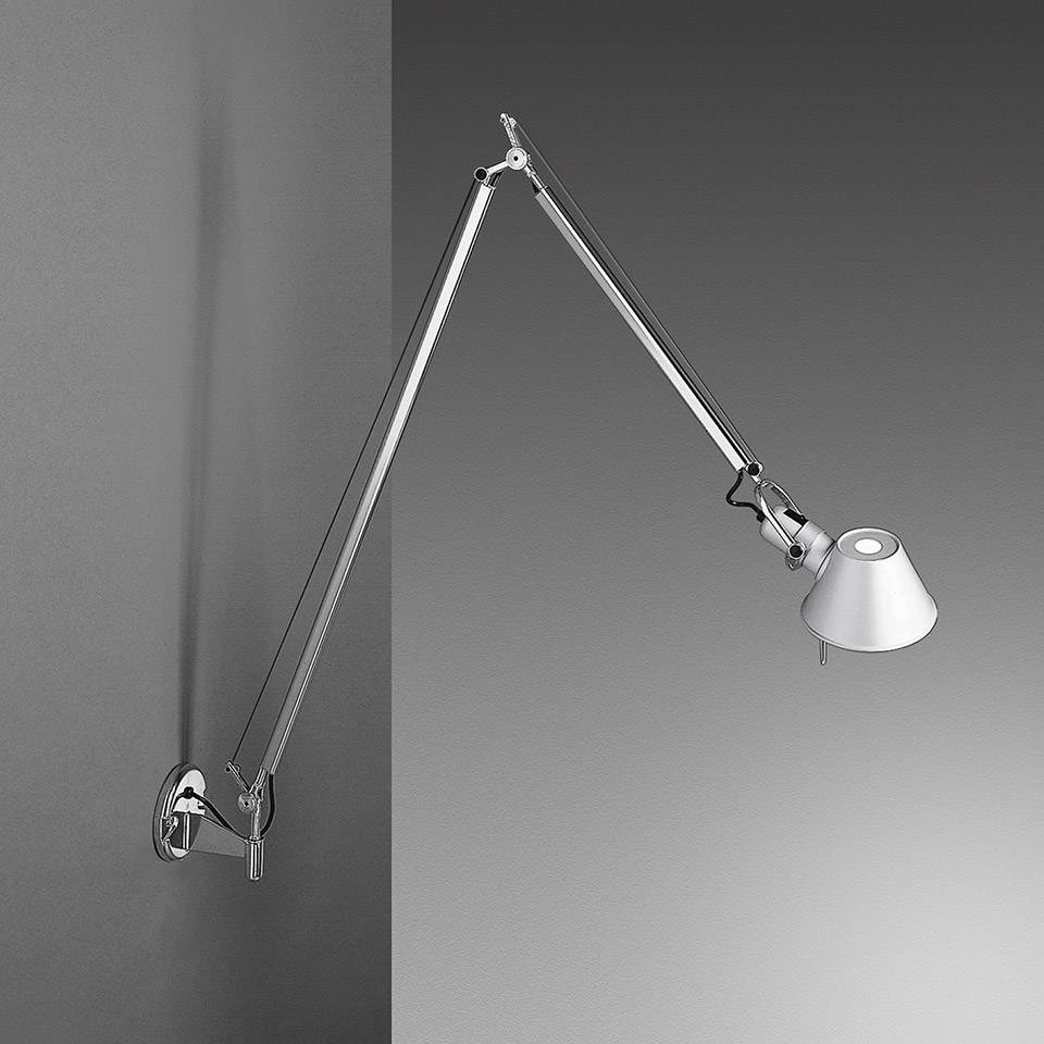 Artemide Tolomeo Parete wall lamp in polished aluminium with two adjustable arms and conical shade, mounted on a corner wall