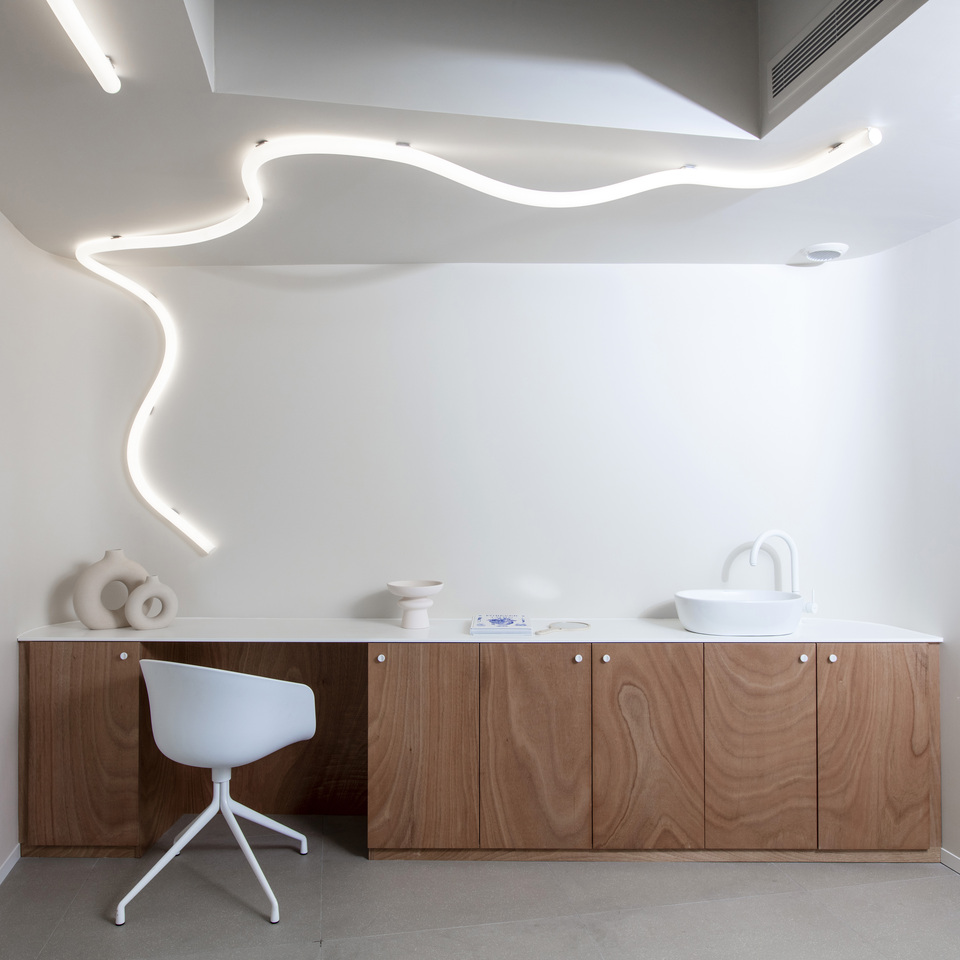 Image of the studio room lit with La Linea running from the ceiling to the wall.