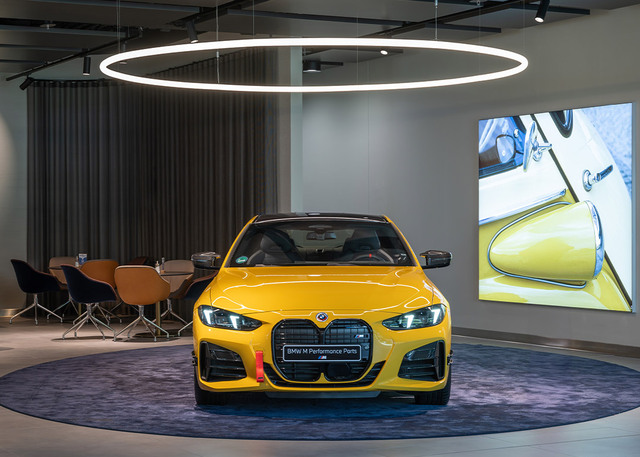 Car centered in the image, lit by Alphabet of Light Suspension Circular.