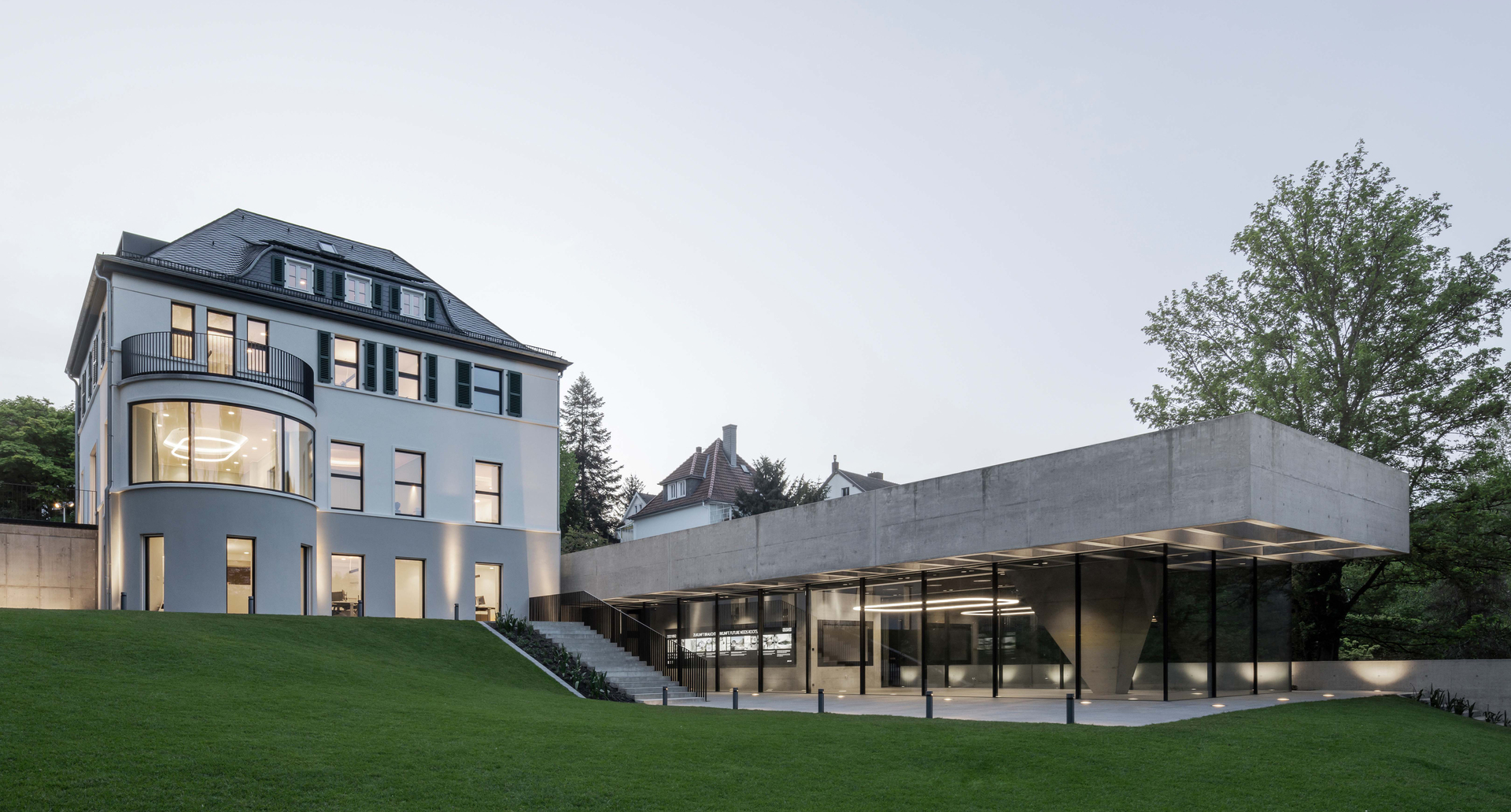 Image of the exterior of the villa showing Alphabet of Light in the main rooms.