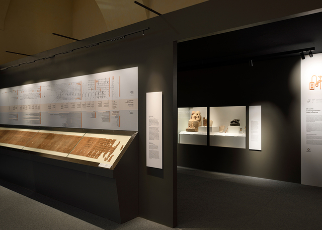 Image of some papyri inside a display case illuminated by Turn Around with Sharp modules