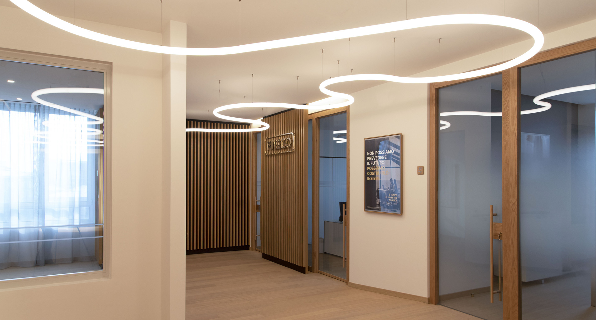 Image of the interior of the offices with the Fineco logo. Composition by Alphabet of Light.