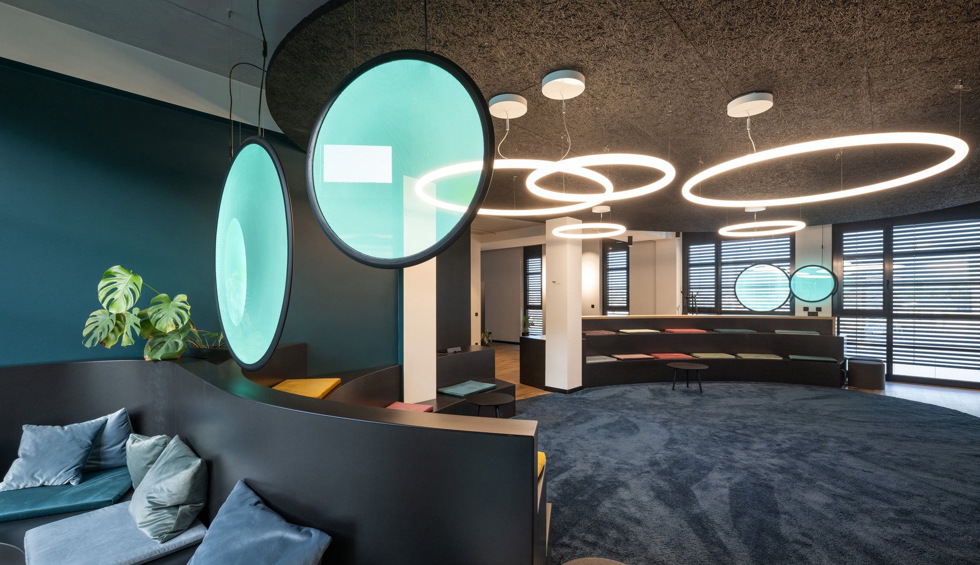 Image of a composition of Discovery Vertical and Alphabet of Light Circular in the office lobby.