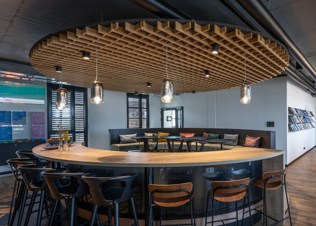 Image of a semi-circular table lit by Gople Suspension and Hoy Spot.