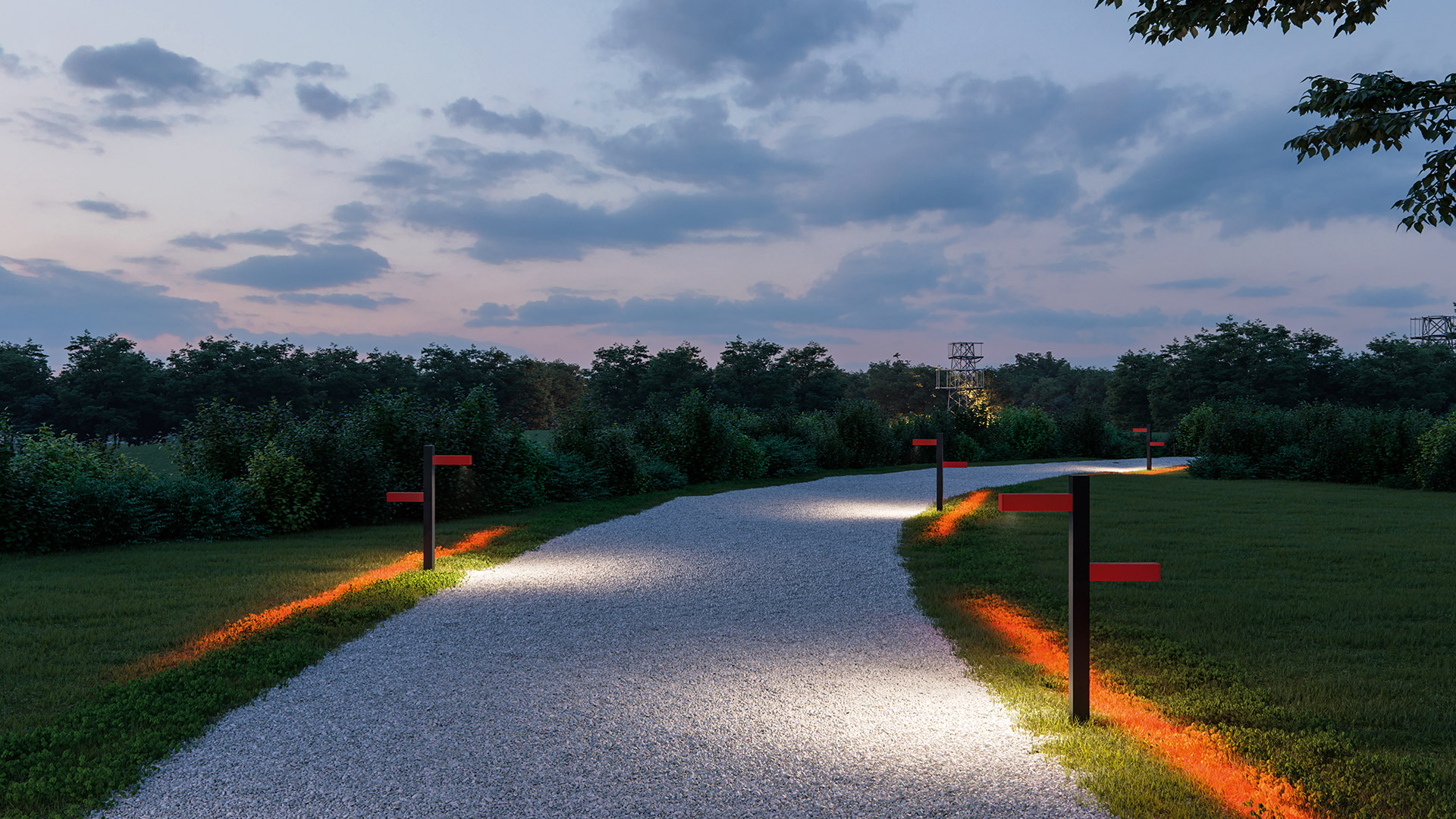 Artemide Walking Palo bollard lights illuminate a winding park path at dusk, casting warm directional light on gravel walkway and grass